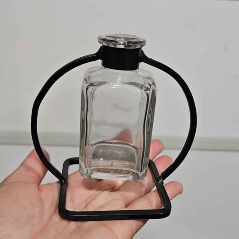 Glass bottle with metal stand